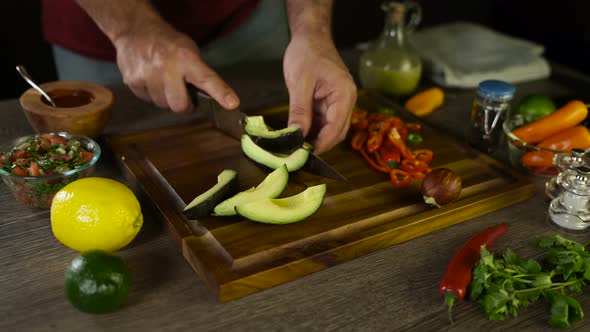 Cutting Avocado on a Wooden Board 