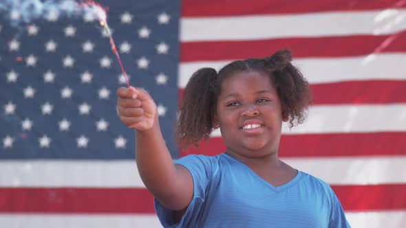 Girl waving sparkler on Fourth of July