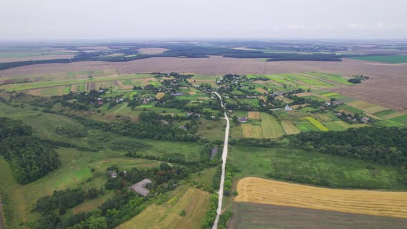 Aerial Above View of Fields and Village House Land Cars Driving on the Road alt