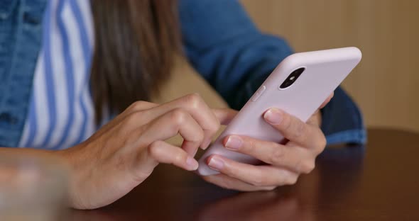 Woman use of smart phone in coffee shop alt