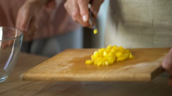 Caring Husband Cooking Fresh Vegetable Salad, Wife Touching His Hand Gently alt