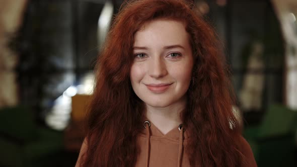 Crop View of Attractive Red Curly Haired Woman Smiling and Looking to Camera alt