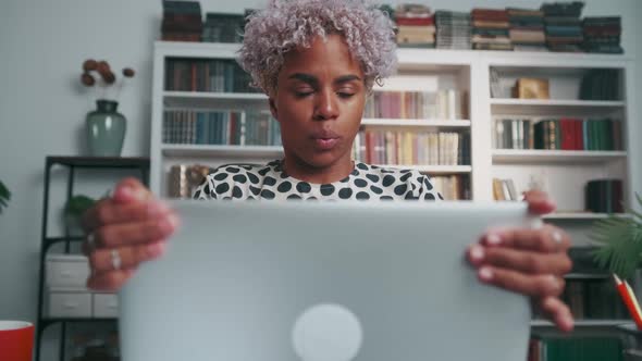 African American Woman Office Worker Closes Laptop and Takes Pose for Meditation alt