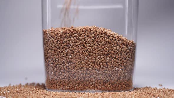 Close-up of Buckwheat Poured Into a Jar for Storage. Useful Food During the Quarantine Period, the alt