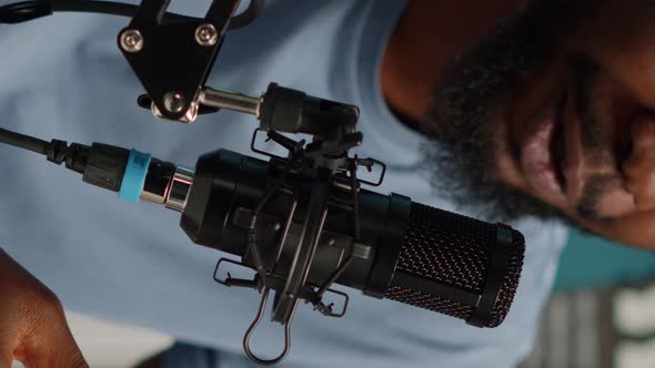 Vertical Video Close Up of Influencer Using Microphone to Talk on Online Podcast alt