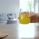 Hand Takes Orange Soda Drink And Put It Back - VideoHive Item for Sale