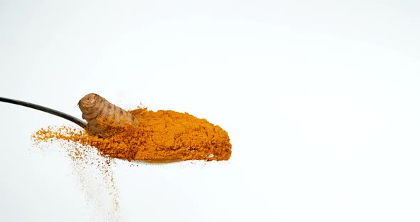 Turmeric, curcuma longa, Root falling on curcuma Powder, Indian Spice, Slow Motion 4K alt