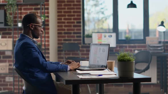 Financial Analyst Using Online Data and Statistics on Laptop alt