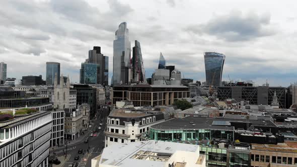 Aerial view slowly approaching the tall skyscrapers in the City of London Financial District alt