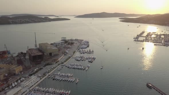 Aerial footage of Trogir port on Adriatic sea at sunset. Boats floats. There are Croatian islands