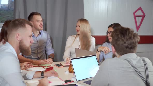 Group of Coworkers Is Meeting in Office Chatting Cheerfully alt