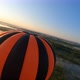 Dynamic aerial shot of black and orange hot air balloon - VideoHive Item for Sale
