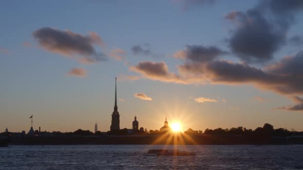 Sun and silhouette of Peter and Paul Fortress in the sunset - St. Petersburg, Russia