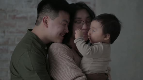 Parents play with an innocent baby. alt