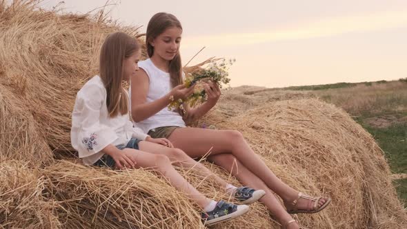 Girls Sitting on Hay alt