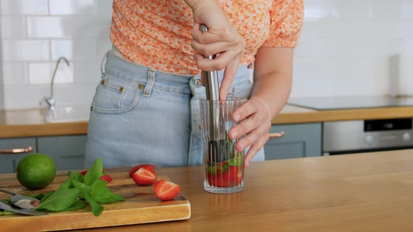 Woman Making Cocktail Drinks at Home Kitchen alt