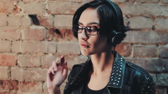 Young Gothic Woman Listening To Music on Headphones alt