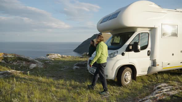 Motorhome RV Camper Van Road Trip Couple Get Out Motorhome and Looking at Sea