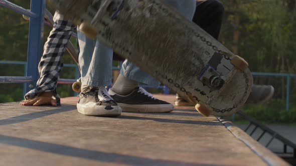 Unrecognizable Teenager Skating Down Ramp alt