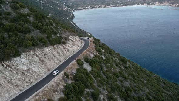 Car Travel Concept Aerial View of Mountain Road Near Sea at Lefkada Island alt
