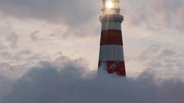 Illuminated Lighthouse Over Fluffy Clouds In The Beautiful Sunset