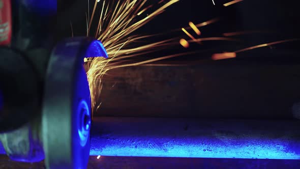 Professional Mechanic Cuts Off Metal Pipe with a Grinder Clamping Them in Vise alt