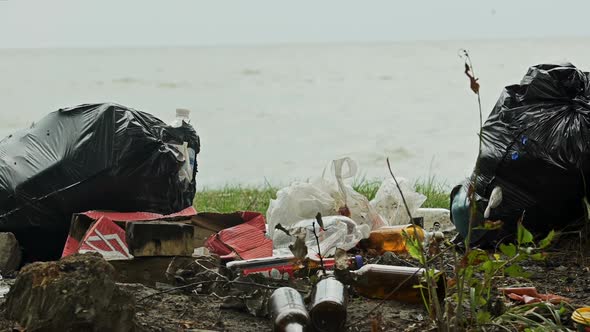 Empty Bottles and Containers Polluting Seashore, Tons of Garbage Damaging Nature alt
