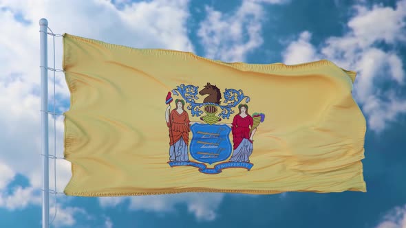 New Jersey Flag on a Flagpole Waving in the Wind Blue Sky Background alt