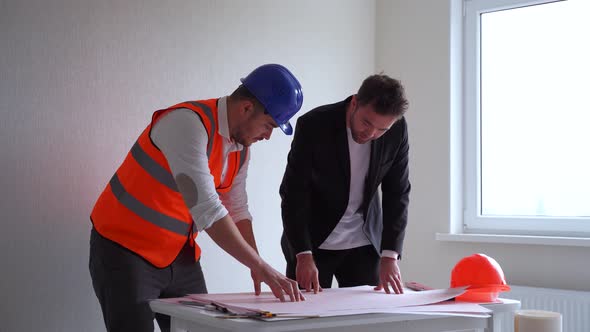Two Men Architect and Engineer in Casual Clothes and Architect in Vest and Hardhat Working with alt