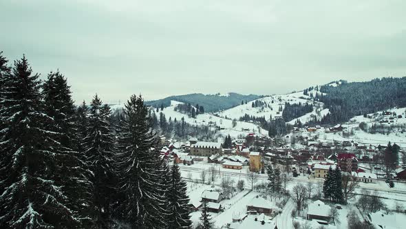 Panoramic View of a Mountain Valley with a Small Town Surrounded By Forest