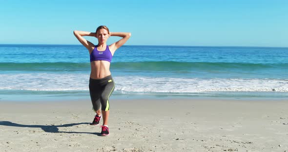 Woman warming up on beach alt