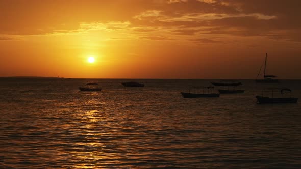Silhouette of Fishing Boats Anchored at Sunset in the Indian Ocean Zanzibar alt