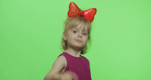 Girl in Purple Dress Dancing and Shows a Finger Forward. Happy Child. Chroma Key alt