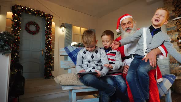 Father Enjoys Kids Playing Role of Santa Claus.