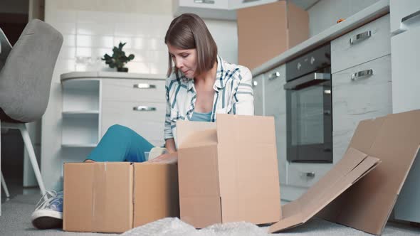 Female Packs Dishes in Kitchen alt