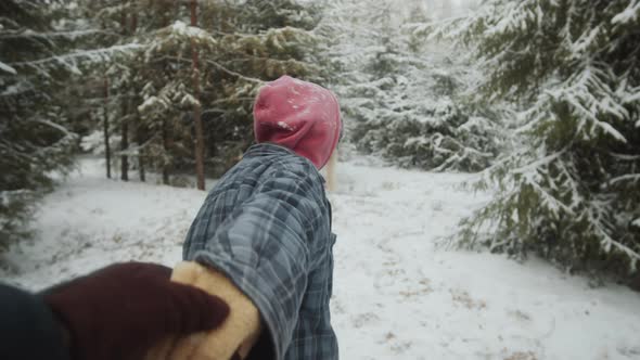POV of Beautiful Woman Walking with Boyfriend through Winter Forest alt