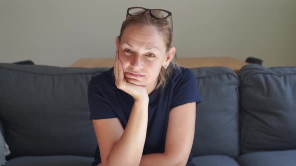 Caucasian Blond 40s 50s Happy Woman Alone on Sofa at Home in Living Room. Happy Middle Age People alt