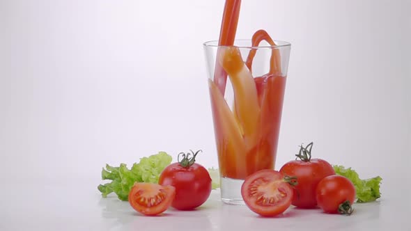 Pouring Tomato Juice Into Glass alt