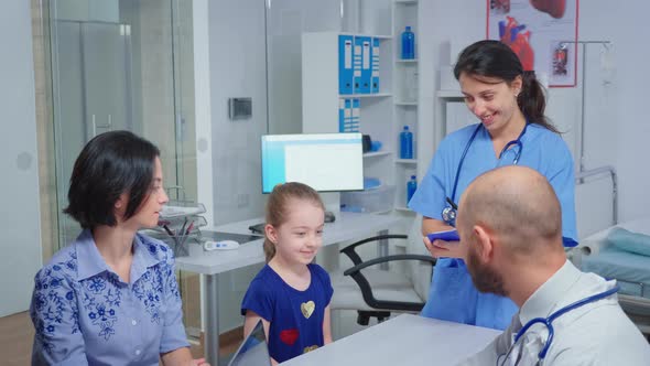 Doctor and Nurse Talking with Child Patient alt