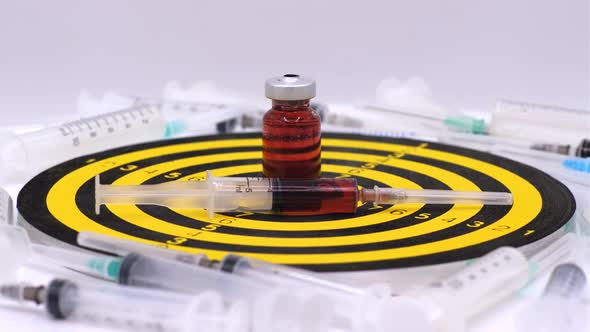 Vaccine bottle with red solution with syringe alt