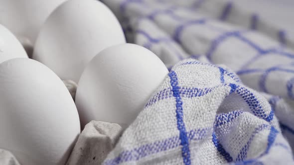 Lots of Fresh Raw Chicken Eggs in a Cardboard Box Rotating Shot Chicken White Fresh Raw Eggs on a alt