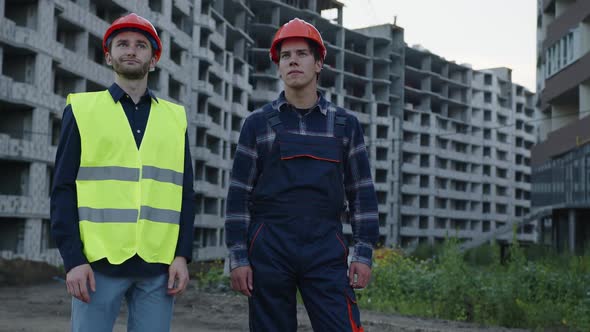 Builders Stand and Look on New Building alt