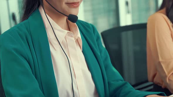 Businesswoman Wearing Headset Working Actively in Office alt