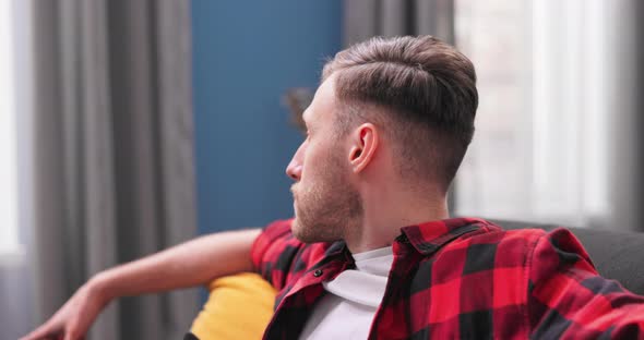 A Male Student in Flannel Shirt is Talking to His Girlfriend on the Phone While alt
