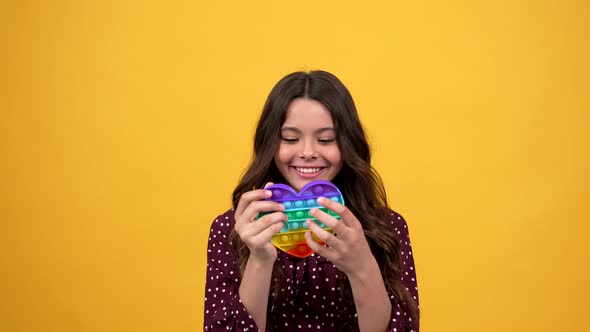 Happy Amazed Child Popping Pop It Antistress Silicone Toy and Dreams Come True alt