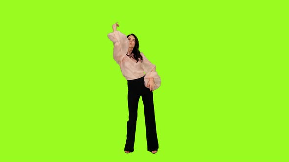 Young Graceful Woman Dancing Emotional Dance on Green Background