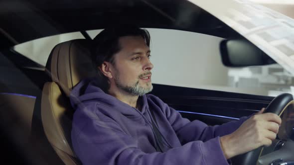 The driver of a premium Bentley car is talking to a passenger. (front-facing shooting). Background c