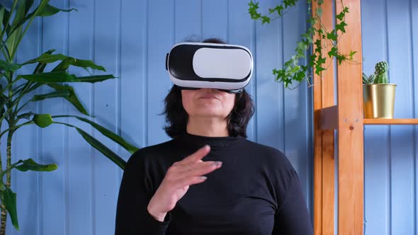 An Elderly Woman Uses Virtual Reality Glasses