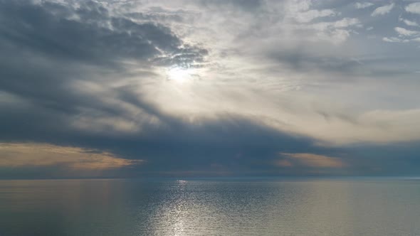 Romantic colorful sunset at the sea. Against the background of the sea, the sun goes down alt