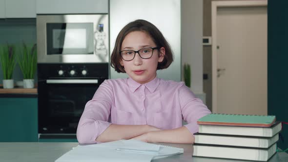 Happy Schoolgirl Pupil Wearing Headphones Raising Hand Distance Learning Online at Virtual Lesson alt
